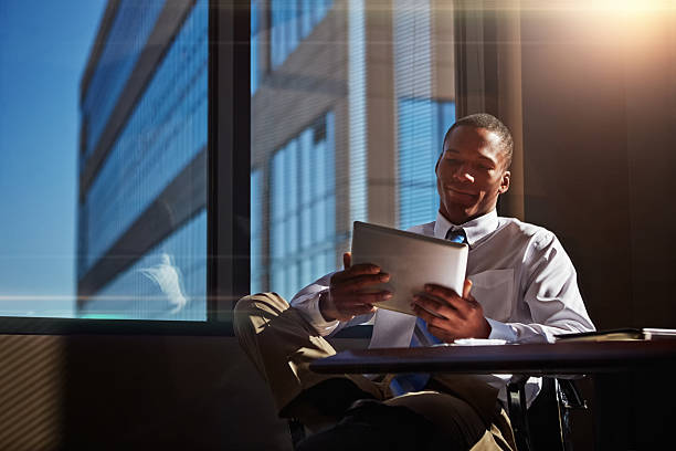 Shot of a businessman using his digital tablet at his desk